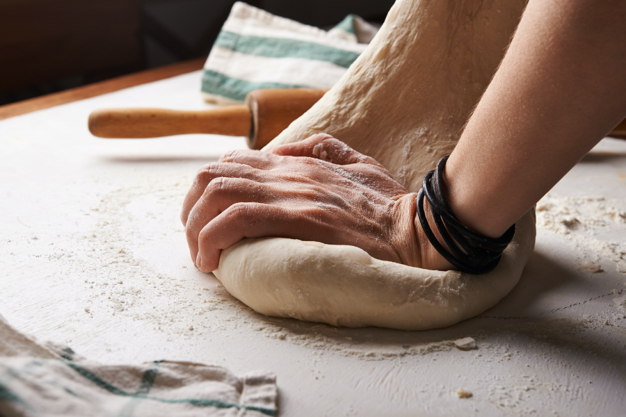kneading bread on a table